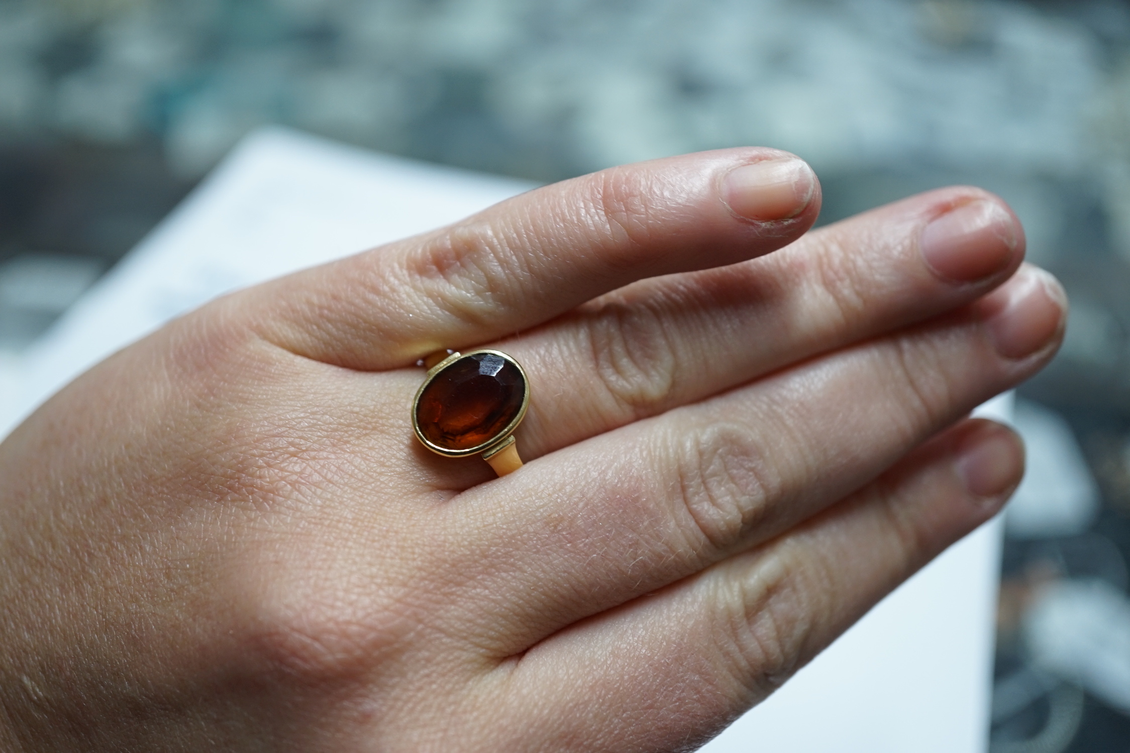 A George V 750 yellow metal and oval cut citrine set ring, size Q, gross weight 5.6 grams.